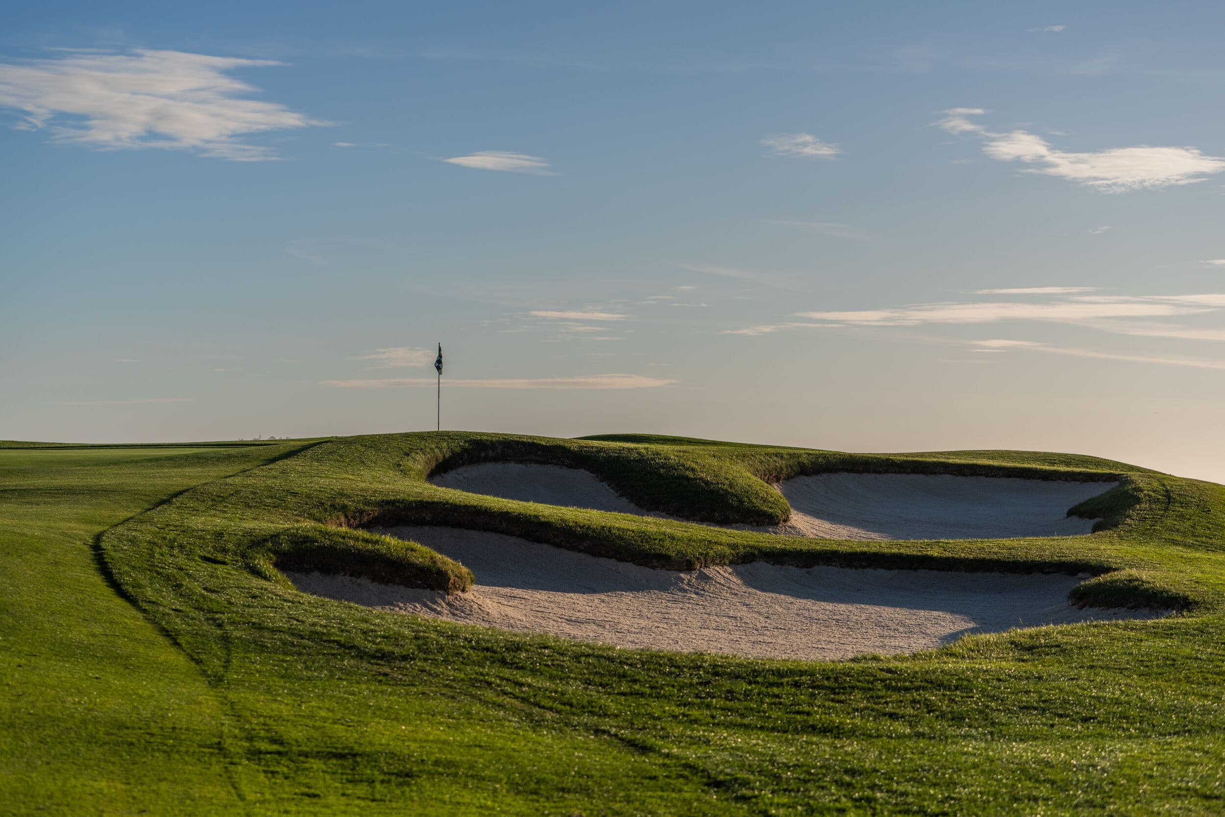 Greenside bunker complex on Hole 6 at Pebble Beach Golf Links® — three sand traps guarding a plateau green