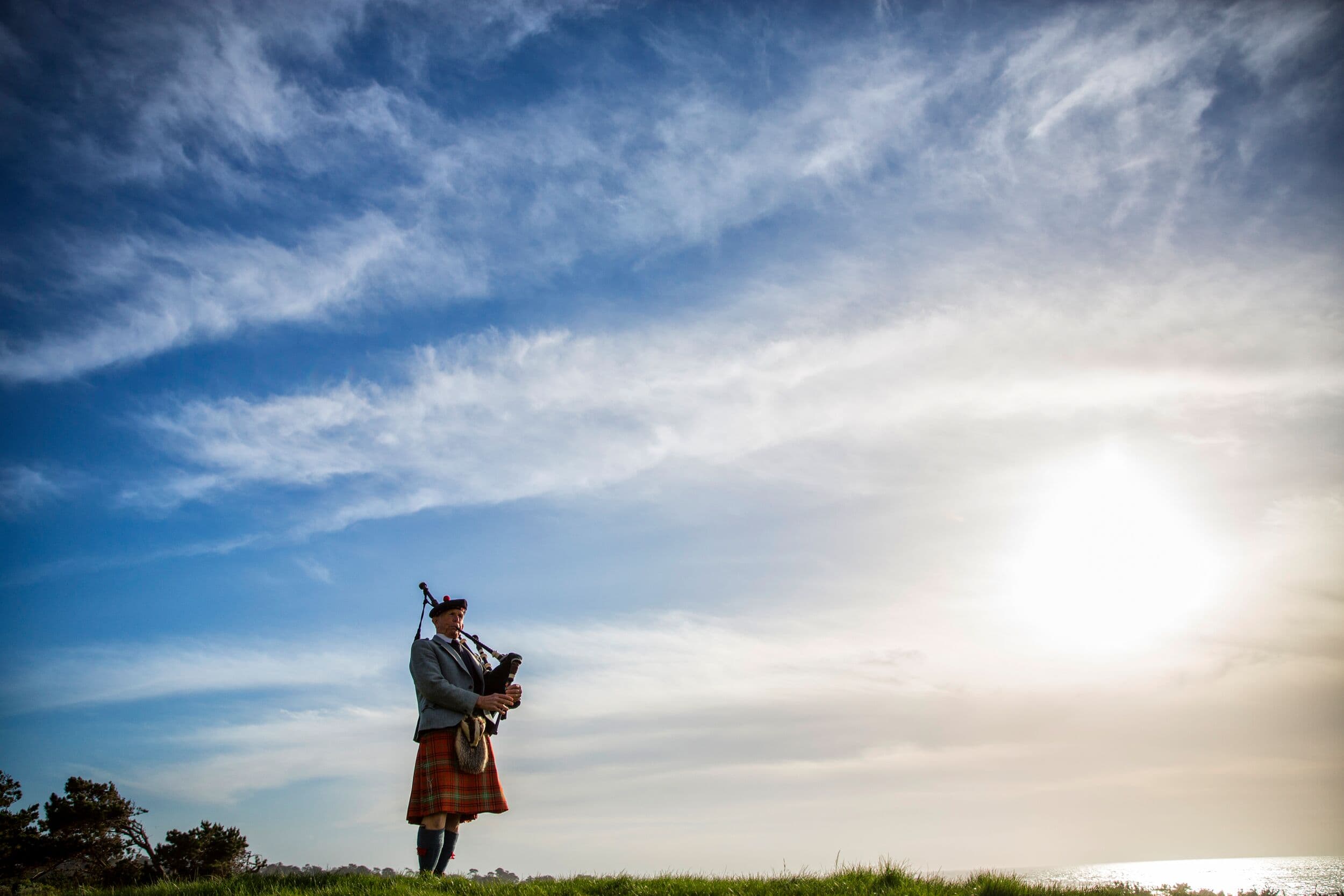 Spanish Bay bagpiper at The Inn at Spanish Bay™, Pebble Beach, CA — at sunset